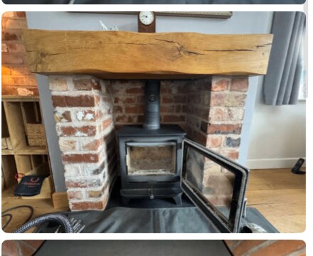 Reclaimed brick fireplace with multi-fuel stove