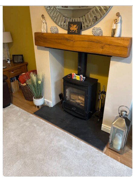 Log burner with oak mantel after a Chimneat sweep